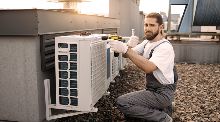 Heating and Air Conditioning Mid Sized HVAC Business Owner Servicing a Rooftop Unit