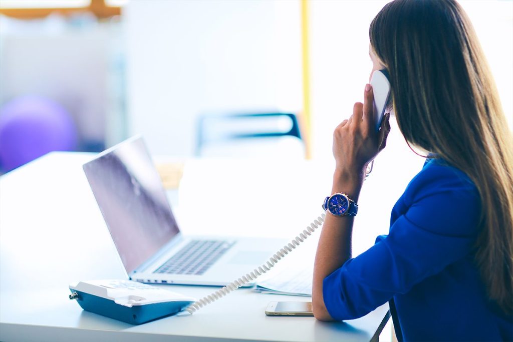 Woman in front of a computer understanding her call booking ratios