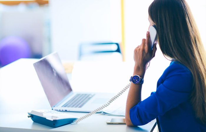 Woman in front of a computer understanding her call booking ratios